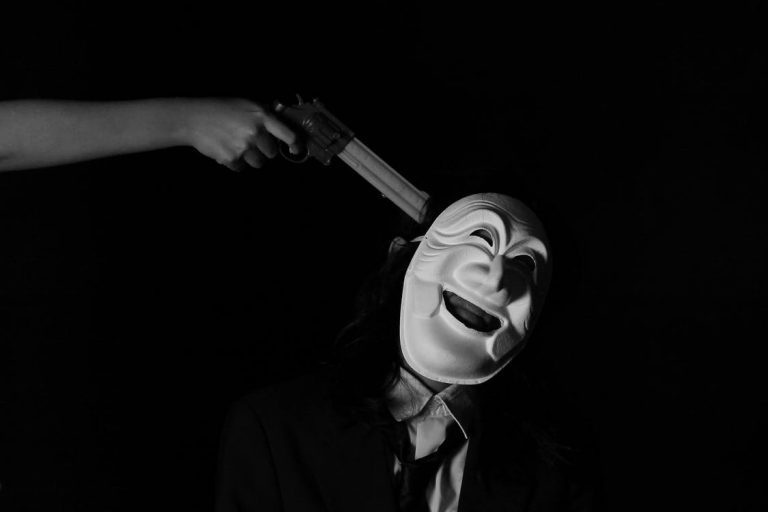 clown with gun at his head