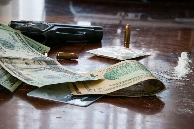 Dollars, bullets, gun and drugs